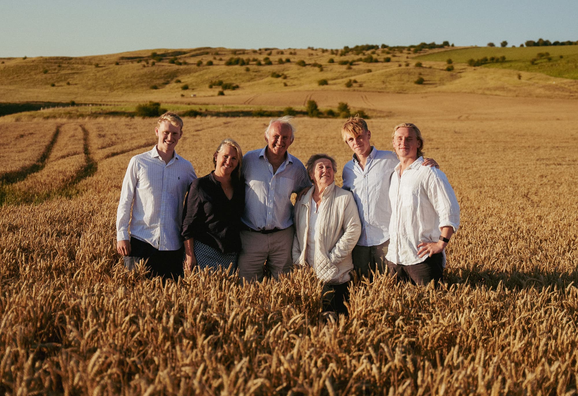 Three generations of the Maundrell family together in the wheat field above the barn