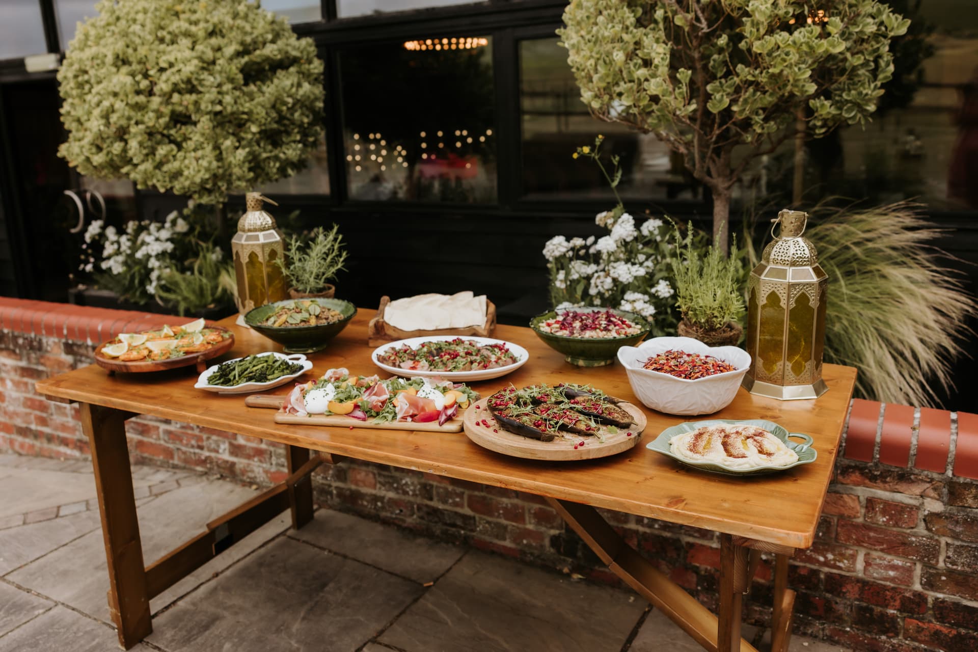 The feast laid out on a long oak table in the courtyard