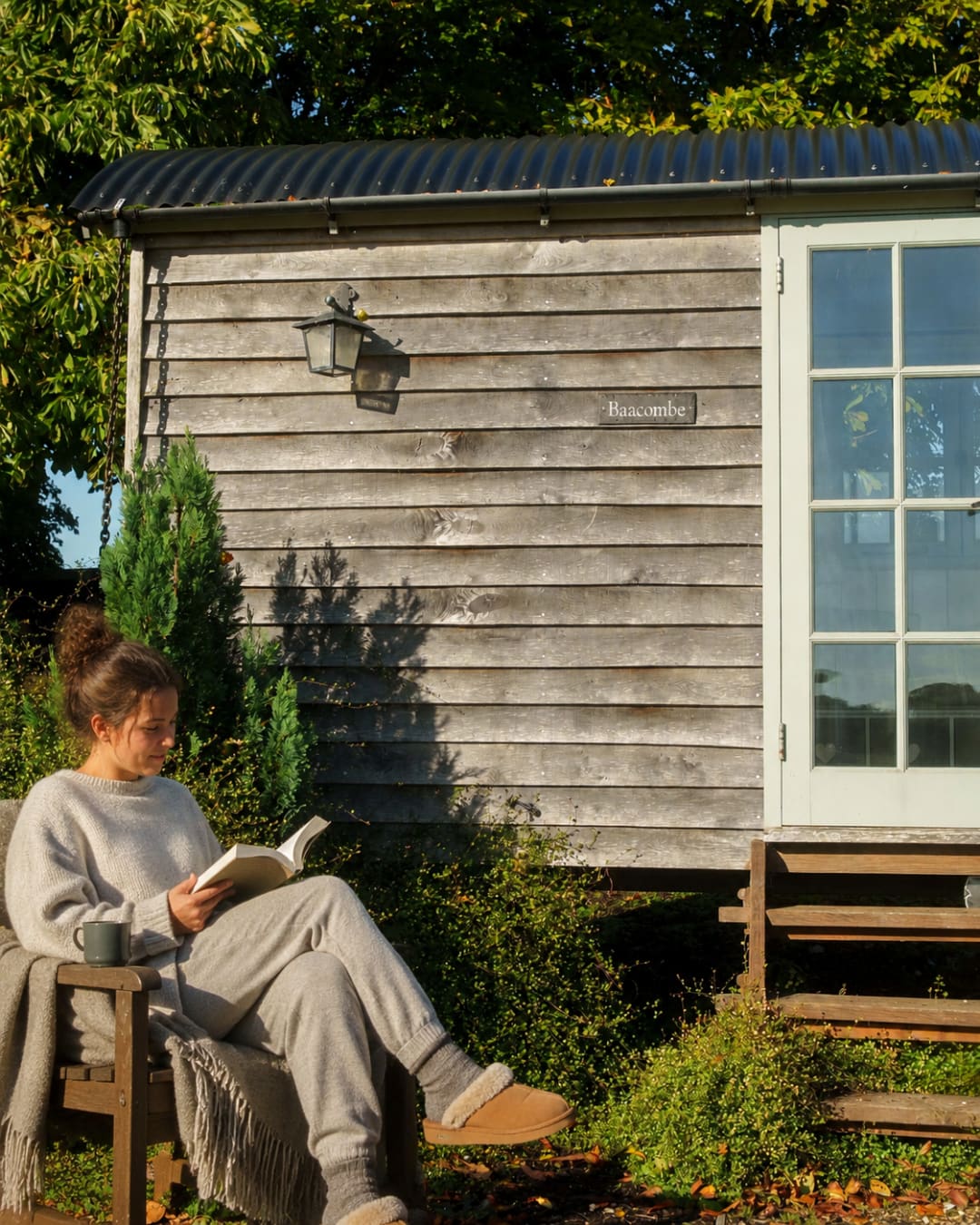 Reading in the sun outside a shepherd hut